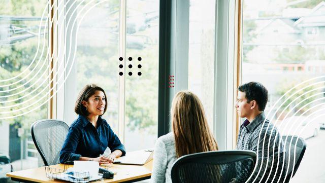 Financial professional sitting at a table with clients